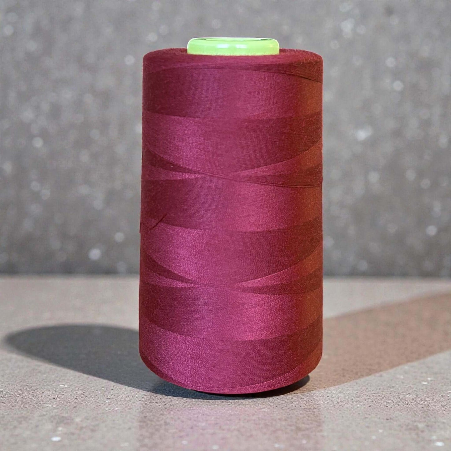 Polyester naaigaren Bordeaux 120 (40/2) op kegel van 5000 meter, sterk en pluisarm naaigaren geschikt voor naaimachine en handnaaien.