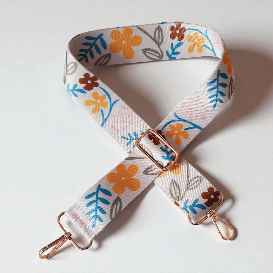 Verstelbare Tassenriem met karabijnhaken in de kleuren Wit, geel, blauw en bruin. Verkrijgbaar bij hobbygaren.nl