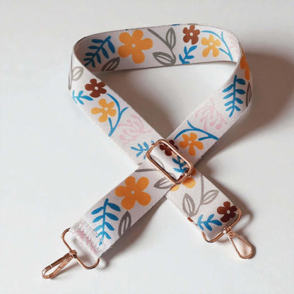 Verstelbare Tassenriem met karabijnhaken in de kleuren Wit, geel, blauw en bruin. Verkrijgbaar bij hobbygaren.nl